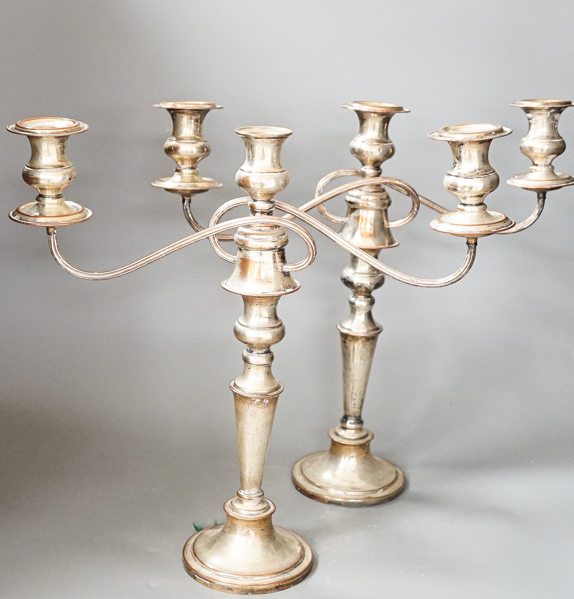 A pair of electroplate on copper free branch candelabra, 40 cms high.